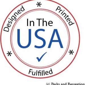 May include: Red and white circular stamp with the text "Designed", "In The USA", "Printed", "Fulfilled", and a checkmark. The text "In The USA" is in blue and the rest of the text is in black.