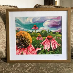 May include: A framed painting of pink coneflowers with yellow centers against a background of swirling blue and purple clouds. The painting is signed "Joy Pettigrew 2023" in the bottom right corner.