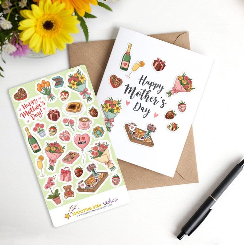 May include: A sheet of stickers with a green background and illustrations of flowers, champagne, chocolate, and other Mother's Day themed items. The text "Happy Mother's Day!" is featured on the sheet. The sheet is next to a white card with the text "Happy Mother's Day" and similar illustrations.