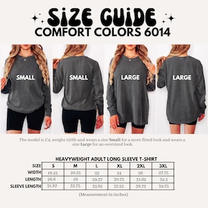 May include: Size guide for Comfort Colors 6014 heavyweight adult long sleeve t-shirts. The image shows models wearing small and large sizes. A size chart provides measurements in inches for sizes S to 3XL, including width, length, and sleeve length.
