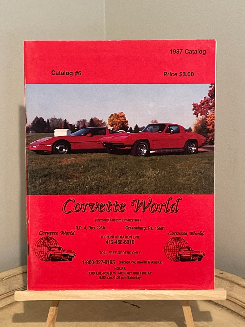 May include: A red 1987 Corvette World catalog with a red Corvette on the cover. The catalog is for sale for $3.00. The catalog is from Kustom Enterprises and includes a toll-free number for ordering.