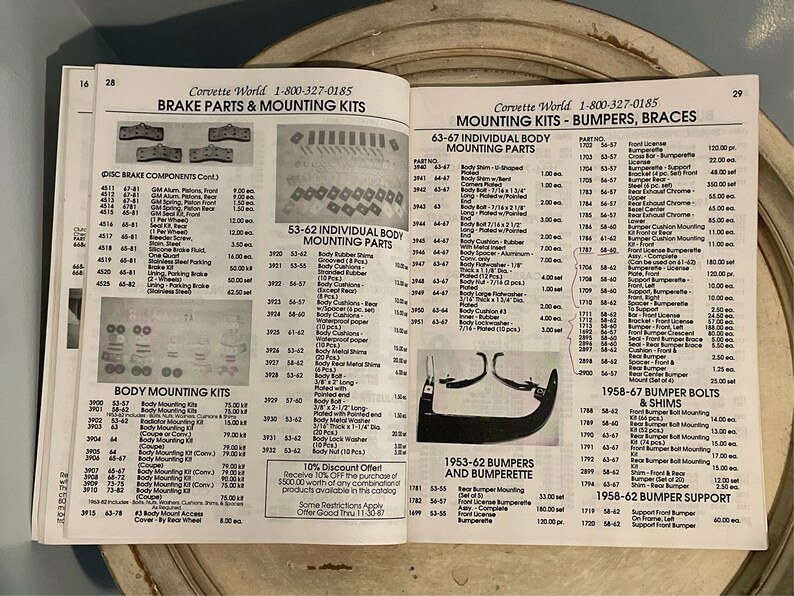 May include: A catalog page with a list of Corvette parts and accessories. The page features a variety of body mounting kits, bumper bolts, and shims. The catalog is organized by year and model. The page also includes a 10% discount offer.