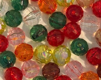 May include: A collection of faceted beads in various colors, including red, orange, green, yellow, pink, and purple. The beads are round and have a crystal-like appearance, reflecting light. These beads are suitable for jewelry making and crafts.
