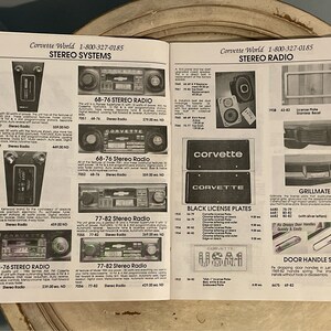 May include: A catalog page featuring Corvette parts and accessories. The page includes a variety of items, such as stereo systems, license plates, door handles, and grillmates. The catalog is from Corvette World and includes prices and part numbers.