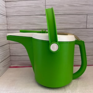 May include: A set of three ceramic mugs with a speckled, matte finish. The mugs are in shades of cream, light gray, and dark gray. Each mug has a simple, minimalist design, perfect for coffee or tea.