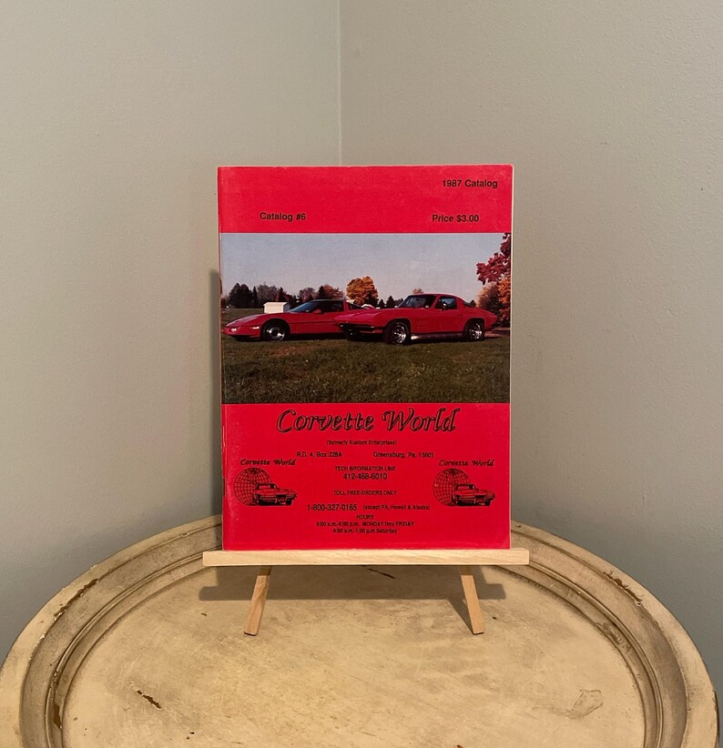 May include: A red Corvette World catalog from 1997, featuring a red Corvette on the cover. The catalog is priced at $3.00 and is catalog #8. The catalog advertises a phone number for Corvette World, 615-484-6210.