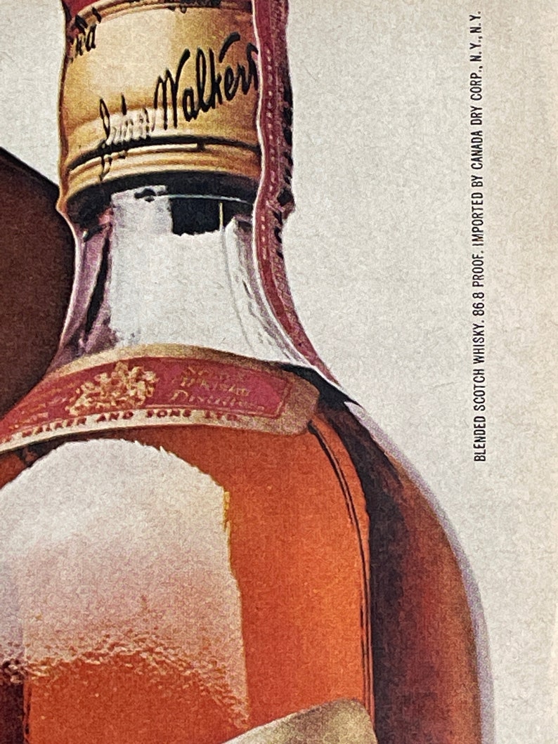 May include: A close-up of a brown glass bottle of blended Scotch whisky with a gold cap that says "Johnnie Walker" on it. The label is red and gold and says "Blended Scotch Whisky, 86.8 Proof, Imported by Canada Dry Corp., N.Y., N.Y."