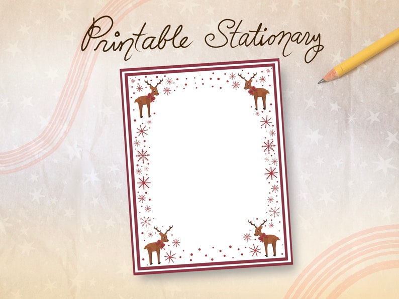May include: Printable stationery with a festive design. The white paper is framed with a burgundy border and adorned with reindeer and snowflake illustrations. The words "Printable Stationery" are written in a decorative font. A yellow pencil rests on the background.