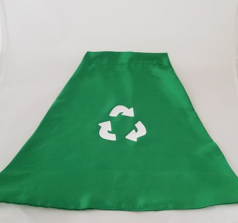 May include: Green fabric cape with a white recycle symbol printed on the front.
