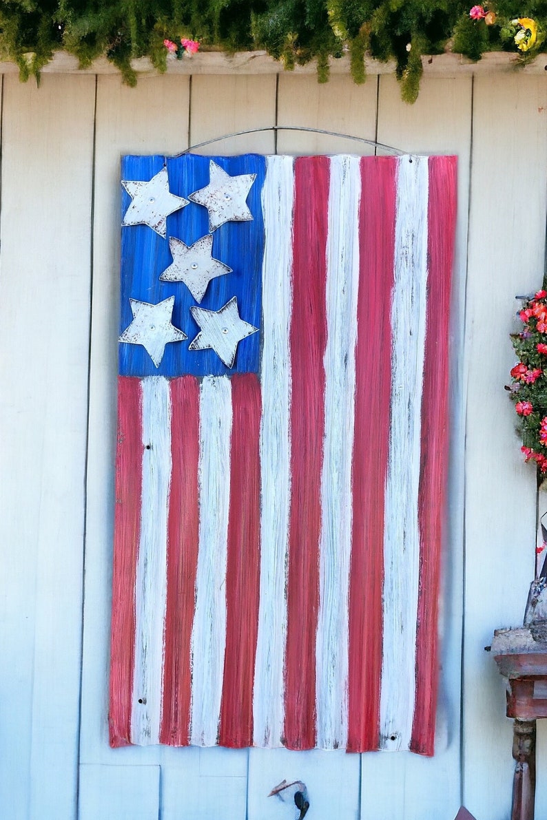 May include: A wooden American flag with red and white stripes and blue stars. The flag is painted in a distressed style, giving it a vintage look.