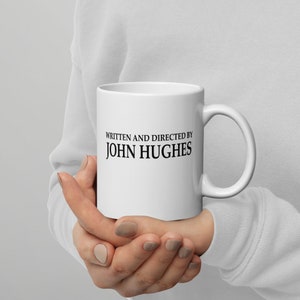 Written And Directed By John Hughes - 11 Ounce White glossy mug