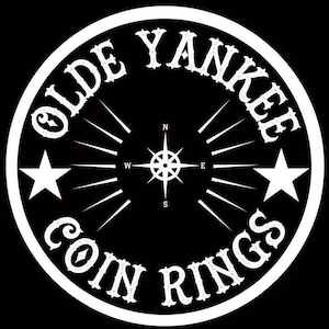 May include: Black and white logo with the text "Olde Yankee Coin Rings" in a circle with a compass and two stars.