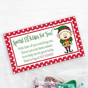May include: A red and white printable gift tag with white polka dots featuring an illustration of an elf holding a bag of candy. The tag reads "Special Elf Kisses For You! With little elf eyes watching you, There's not a lot Santa misses. So to help you be good today, Here's a bag of ELF KISSES."