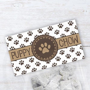 May include: Printable favor bag label with a brown paw print pattern and the text "Puppy Chow" in a brown banner. The label is designed to fit over 4 inch and 6.5 inch bags.