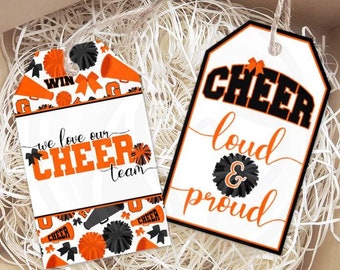 May include: Two printable gift tags with a cheerleading theme. One tag features a black and orange cheerleading pattern with the text "we love our cheer team". The other tag has the text "cheer loud & proud" in black and orange.