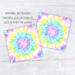May include: Two square box backers with a vibrant tie-dye design in shades of pink, yellow, blue, and green. The text on the image reads: PRINTABLE BOX BACKERS, MULTIPLE SIZES INCLUDED IN EASY TO PRINT PDF FORMAT.