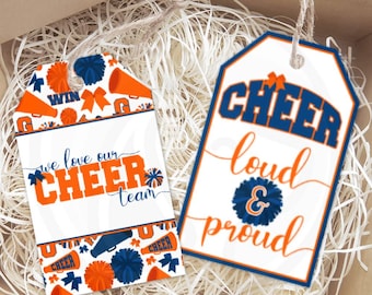 May include: Two white gift tags with blue and orange cheerleading themed designs. One tag says "We love our cheer team" and the other says "Cheer loud & proud".