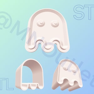 May include: Three off-white ghost-shaped cookie cutters. The ghost designs have rounded tops, eye details, and wavy bottoms. The word "STL" is visible in the background. The background is a gradient of light blue and teal.