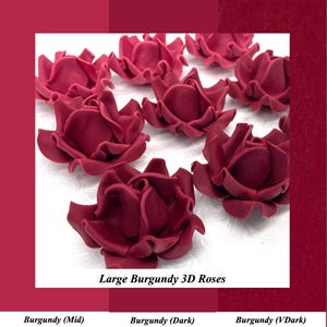 May include: A collection of large, burgundy-colored 3D roses. The image displays several of these floral decorations, showcasing their detailed petal structure. The text on the image reads "Large Burgundy 3D Roses."