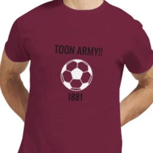 May include: Maroon t-shirt featuring a white football graphic and the text "TOON ARMY!!" above it. The number "1881" is below the football. The shirt is a solid maroon colour.