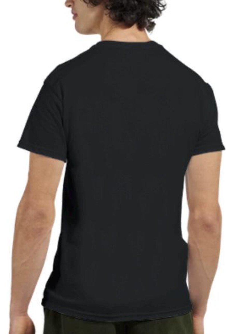 May include: A plain black short-sleeved t-shirt. The shirt is made of a soft material and has a crew neck. The back of the shirt is visible, with the shoulders and upper back in focus. A simple, everyday garment.