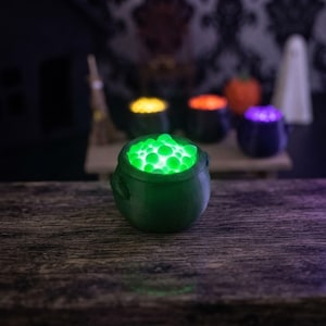 Miniature Light-Up Witch Cauldron, Mini Spooky Halloween Decor, 3D Printed Diorama Accessory shown in an AI-generated listing photo