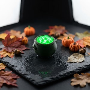 Miniature Light-Up Witch Cauldron, Mini Spooky Halloween Decor, 3D Printed Diorama Accessory shown in an AI-generated listing photo