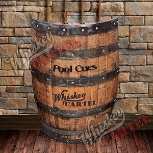 May include: A wooden barrel with metal bands and a sign that says "Whiskey Cartel" and "Pool Cues".