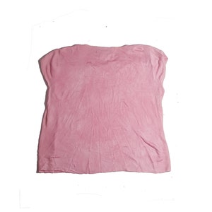 May include: A pink short-sleeved shirt made of a soft, textured fabric.
