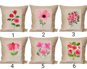 May include: Six decorative throw pillow covers with a beige background and brown stripes. Each pillow cover features a different pink floral design, including roses, anemones, and a bouquet of flowers.
