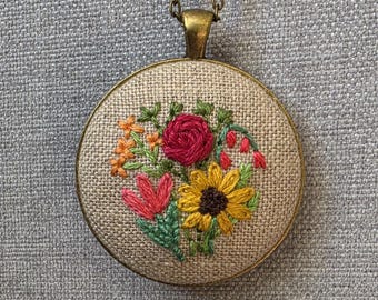 Boho embroidery designs flower necklace. Hand stitched flower bouquet pendant stitched with colorful cotton on linen. Fine art jewelry.
