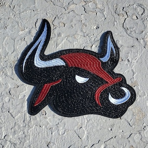 May include: Black and red embroidered bull head patch with white horns.