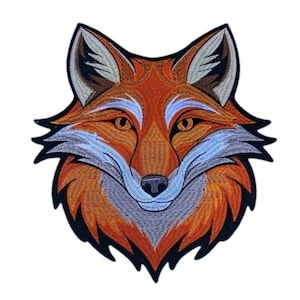May include: An embroidered patch featuring the head of a fox with orange, brown, and white thread detailing. The design includes pointed ears, amber eyes, a black nose, and a thick black border outlining the entire shape of the fox head.