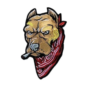 May include: An embroidered patch featuring a tan pit bull dog with a stern expression, wearing a red bandana with white patterns around its neck. The dog has a cigarette in its mouth and yellow decorative line accents on its forehead and cheek.