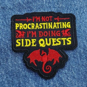 May include: A white ceramic mug with a black handle and the text "But First, Coffee" in a black, bold font. The mug is sitting on a wooden surface. The mug is approximately 4 inches tall.