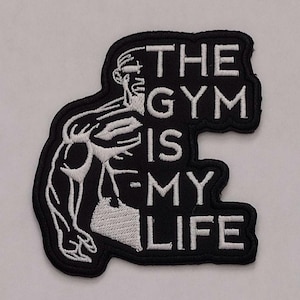 May include: Black and white embroidered patch with a muscular figure and the text "The Gym Is My Life".