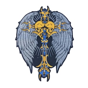 May include: Embroidered patch featuring a cross design with angel wings. The cross is adorned with skulls and intricate gold and blue detailing. The wings are gray, and the background is black.