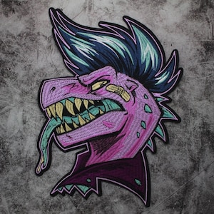 May include: An embroidered patch featuring a pink dinosaur with a blue and green mohawk, a purple jacket, and a long green tongue sticking out. The dinosaur has a fierce expression and is set against a gray background.