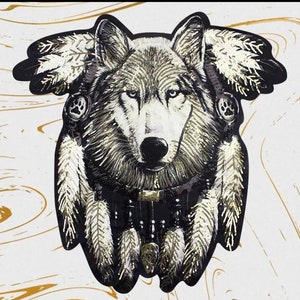 May include: A black and white wolf with a dreamcatcher made of feathers and beads. The wolf's eyes are black and the dreamcatcher is decorated with gold beads.