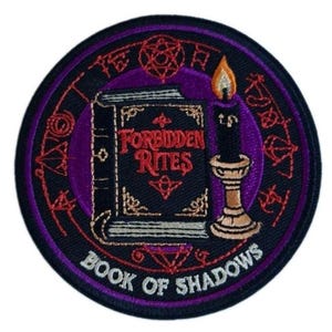 May include: A circular embroidered patch featuring a black book with the red text Forbidden Rites, a lit black candle in a tan holder, and a purple background. The border contains red occult symbols and the white text Book of Shadows.