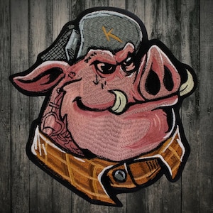 May include: Embroidered patch of a cartoon pig wearing a plaid shirt, a gray and black hat with a letter K on it, and a smirk. The pig has large tusks and a pink snout.