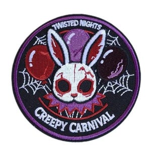 May include: A circular embroidered patch featuring a white rabbit head with red accents, surrounded by red and dark purple balloons and white spiderwebs on a black background. The text reads TWISTED NIGHTS at the top and CREEPY CARNIVAL at the bottom.