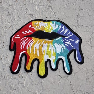 May include: Rainbow colored embroidered iron-on patch of a dripping, melting, open mouth with a black outline.