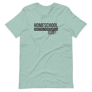 Puede incluir: Una camiseta azul claro con el texto "HOMESCHOOL SUBSTITUTE TEACHER NEEDED ASAP!" impreso en negro.