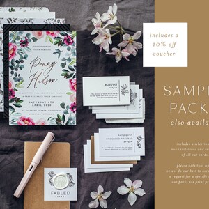May include: Wedding stationery set with floral invitations, sample cards, and a pen. The main invitation features the names "Penny + Hudson" surrounded by pink and purple flowers and greenery. Includes a 10% off voucher and the text "Sample Packs".