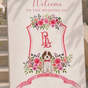May include: A rectangular wedding welcome sign on a wooden easel featuring the text Welcome TO THE WEDDING OF, a pink crest with the monogram BL, a watercolour illustration of a dog with a red bow tie, and the text SEPTEMBER 19, 2026 BRIDGET and LOUIS.