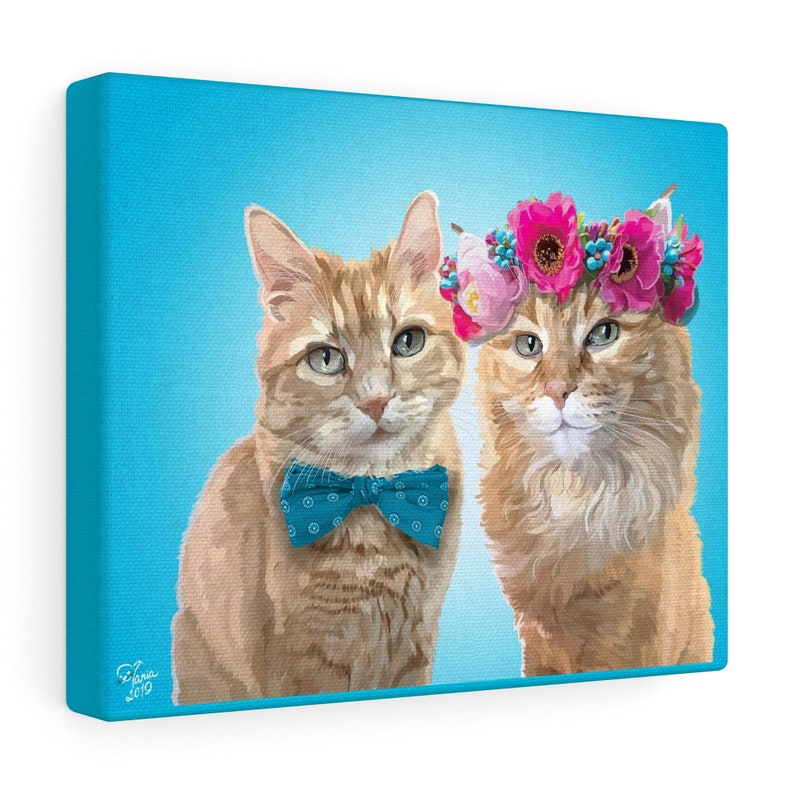 May include: A canvas print featuring two orange tabby cats against a light blue background. One cat wears a blue bow tie, and the other wears a floral crown. The artwork is signed "Elena 2019".