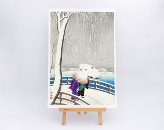 Two women in the snow on Yanagi Bridge (1927) by Ohara Koson - Fine art print with fringed edge