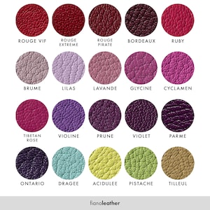 May include: A chart of 15 different leather colors with their French names. The colors range from red to purple to green. The leather is textured and has a natural look.