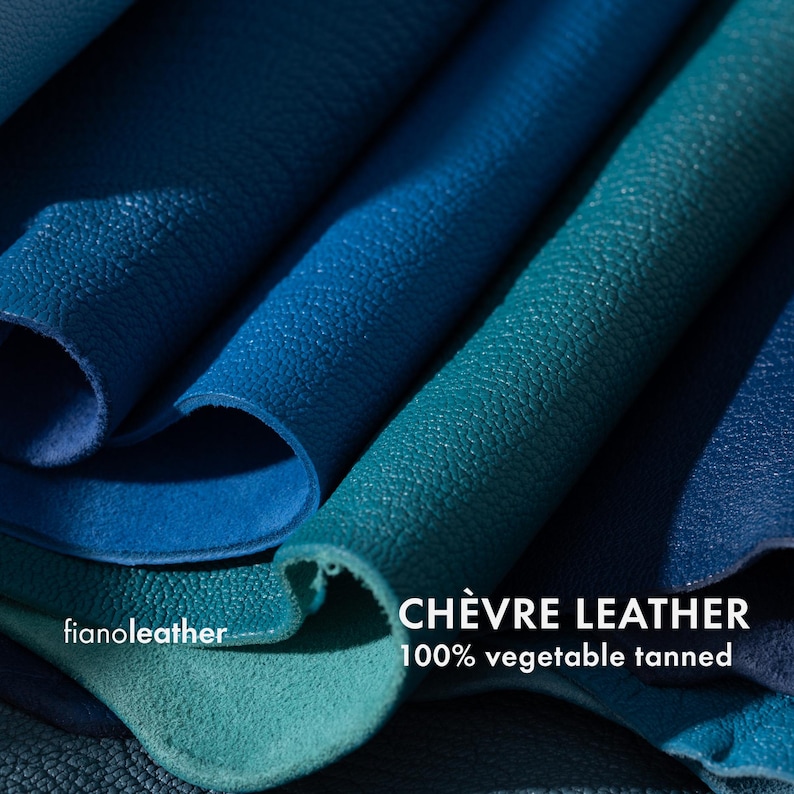 May include: Close-up of several pieces of blue and green leather. The leather is folded and textured. The text "CH&Egrave;VRE LEATHER 100% vegetable tanned" is visible at the bottom of the image.